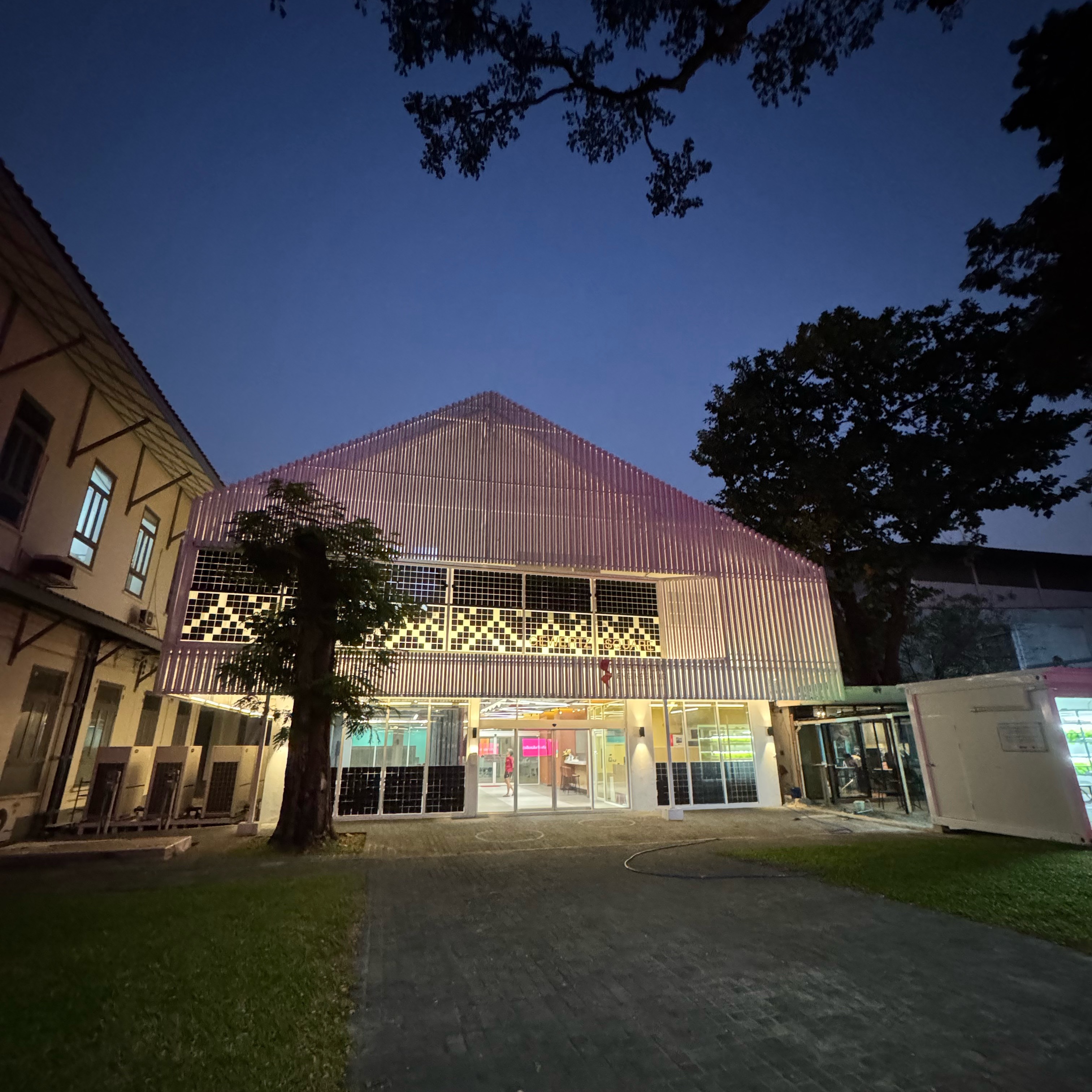 GEWERTZ Square building at night, illuminated facade